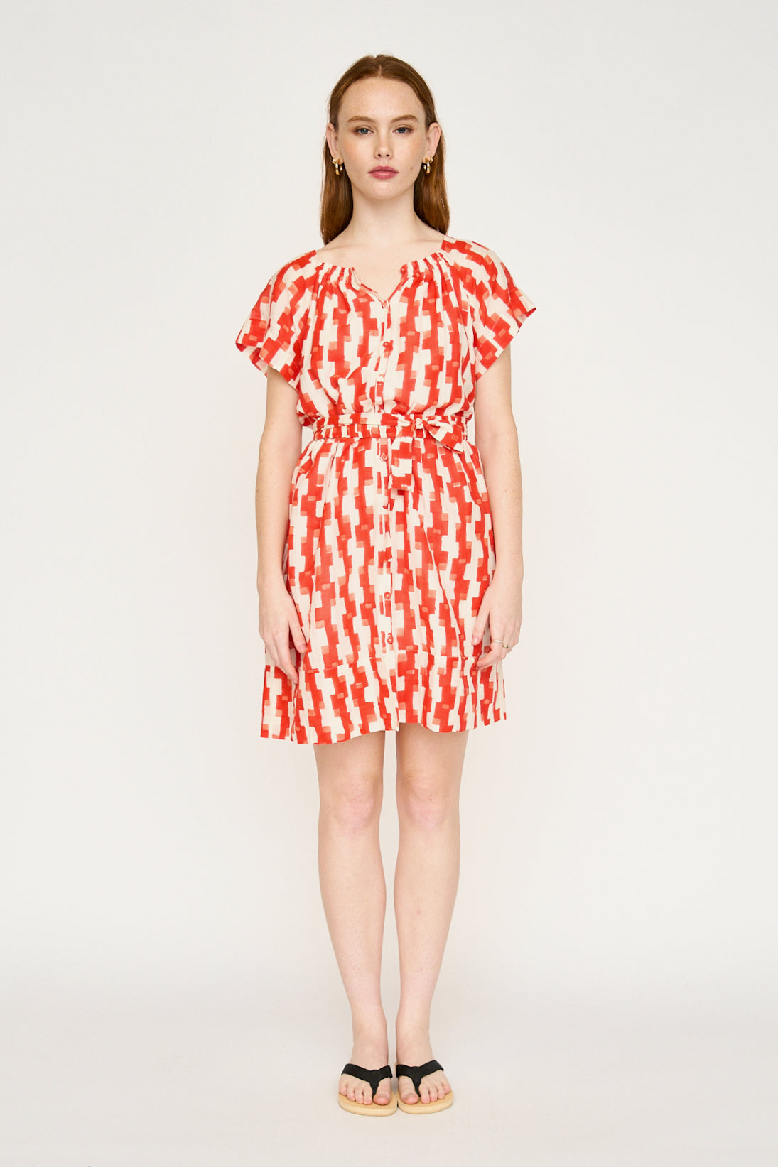 Red cotton short dress on a hanger in store
