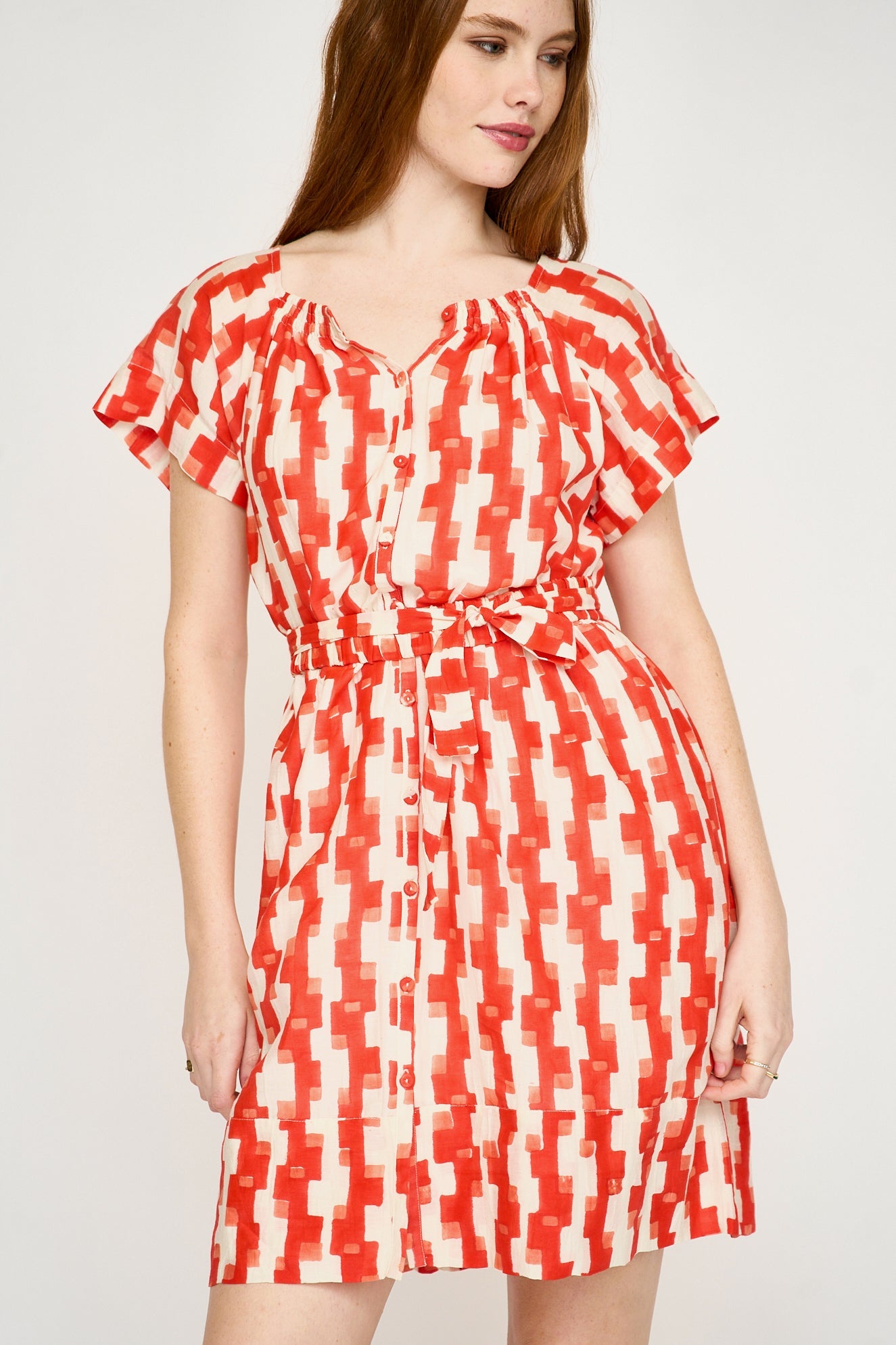 Red cotton short dress on a hanger in store