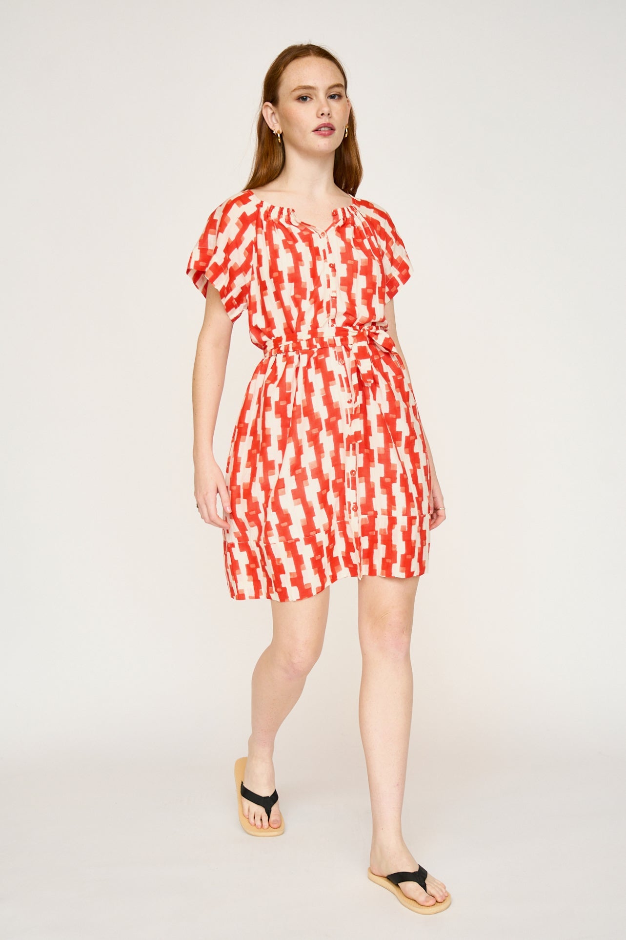 Red cotton short dress on a hanger in store