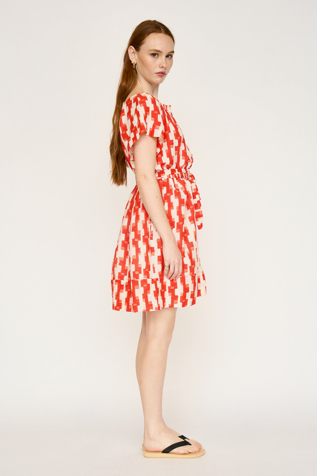Red cotton short dress on a hanger in store