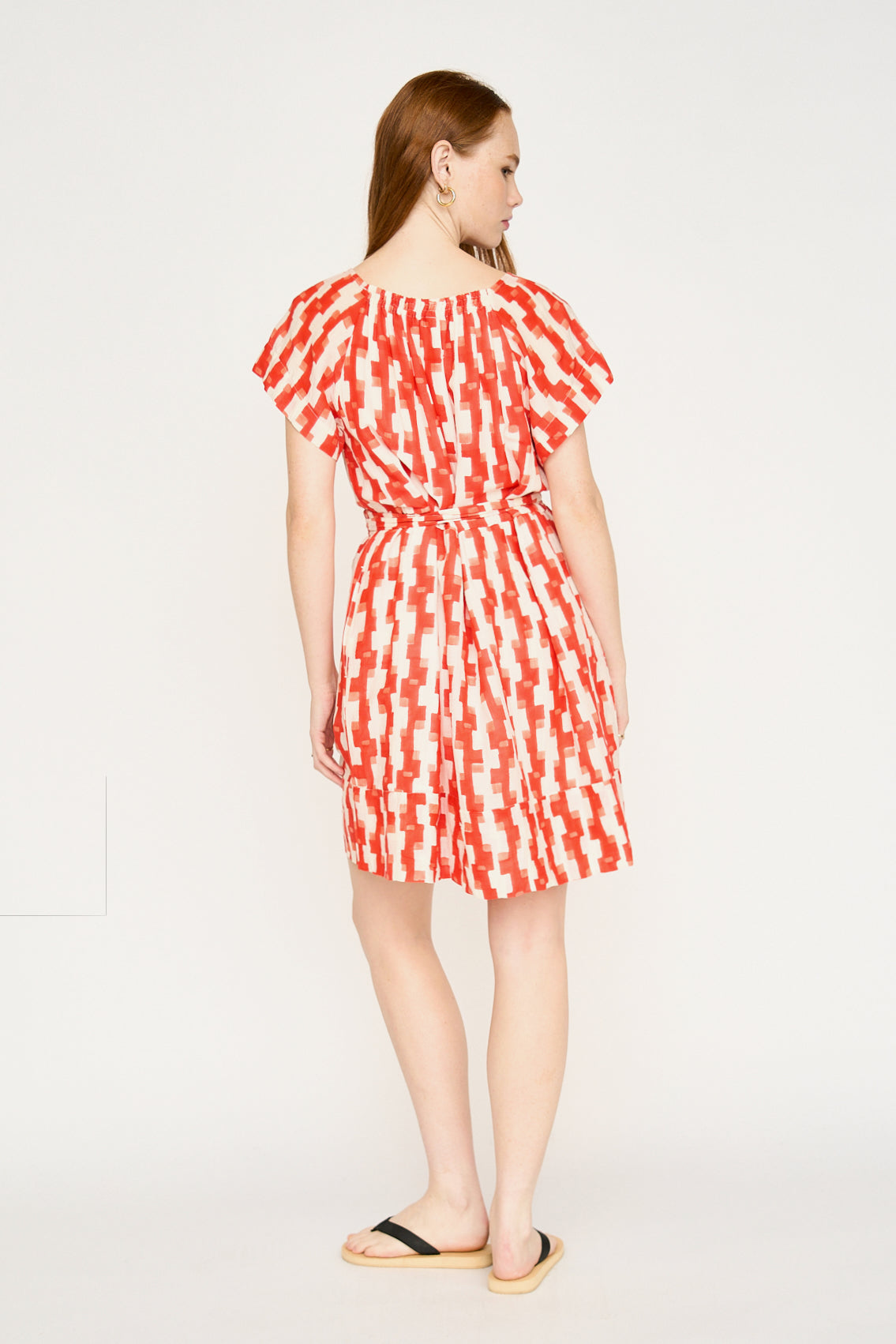 Red cotton short dress on a hanger in store