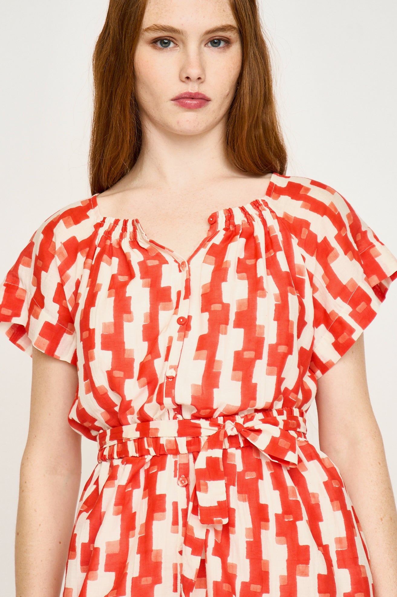 Red cotton short dress on a hanger in store