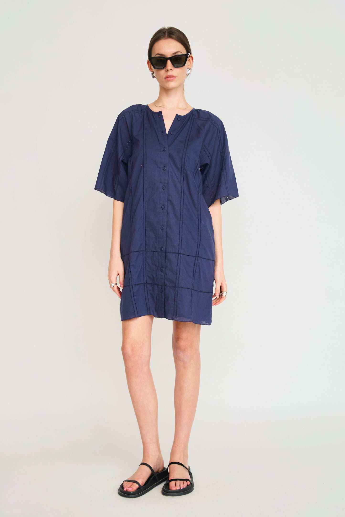 Blue cotton short dress on a hanger in store