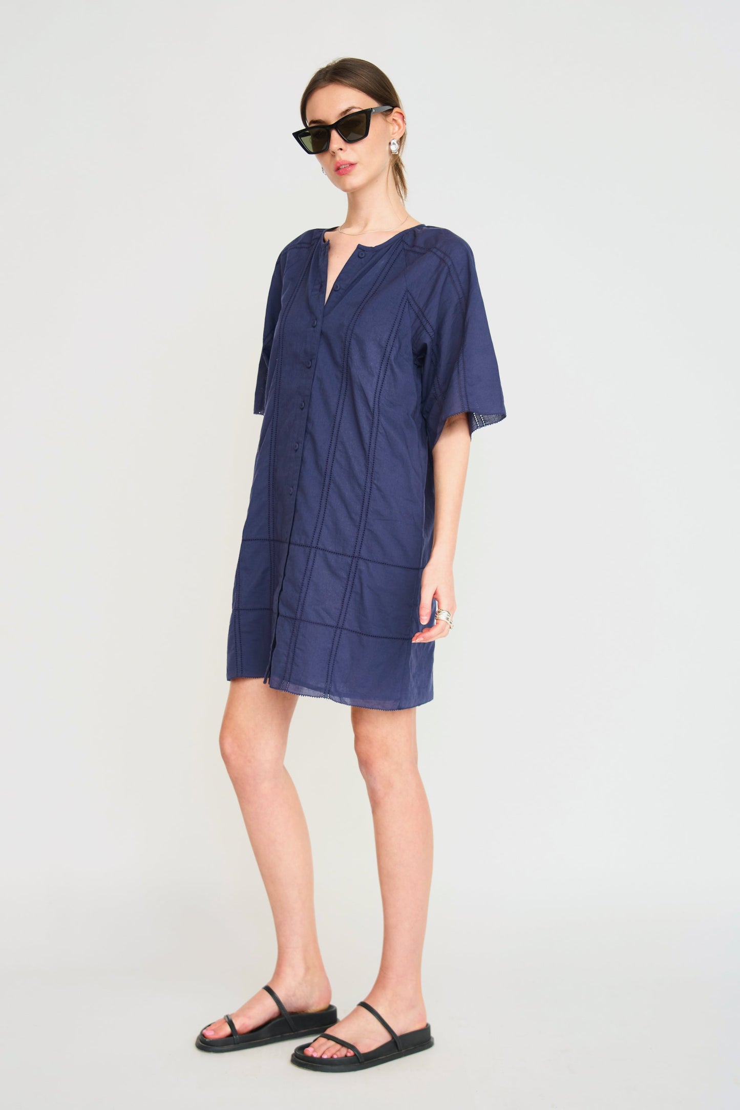 Blue cotton short dress on a hanger in store