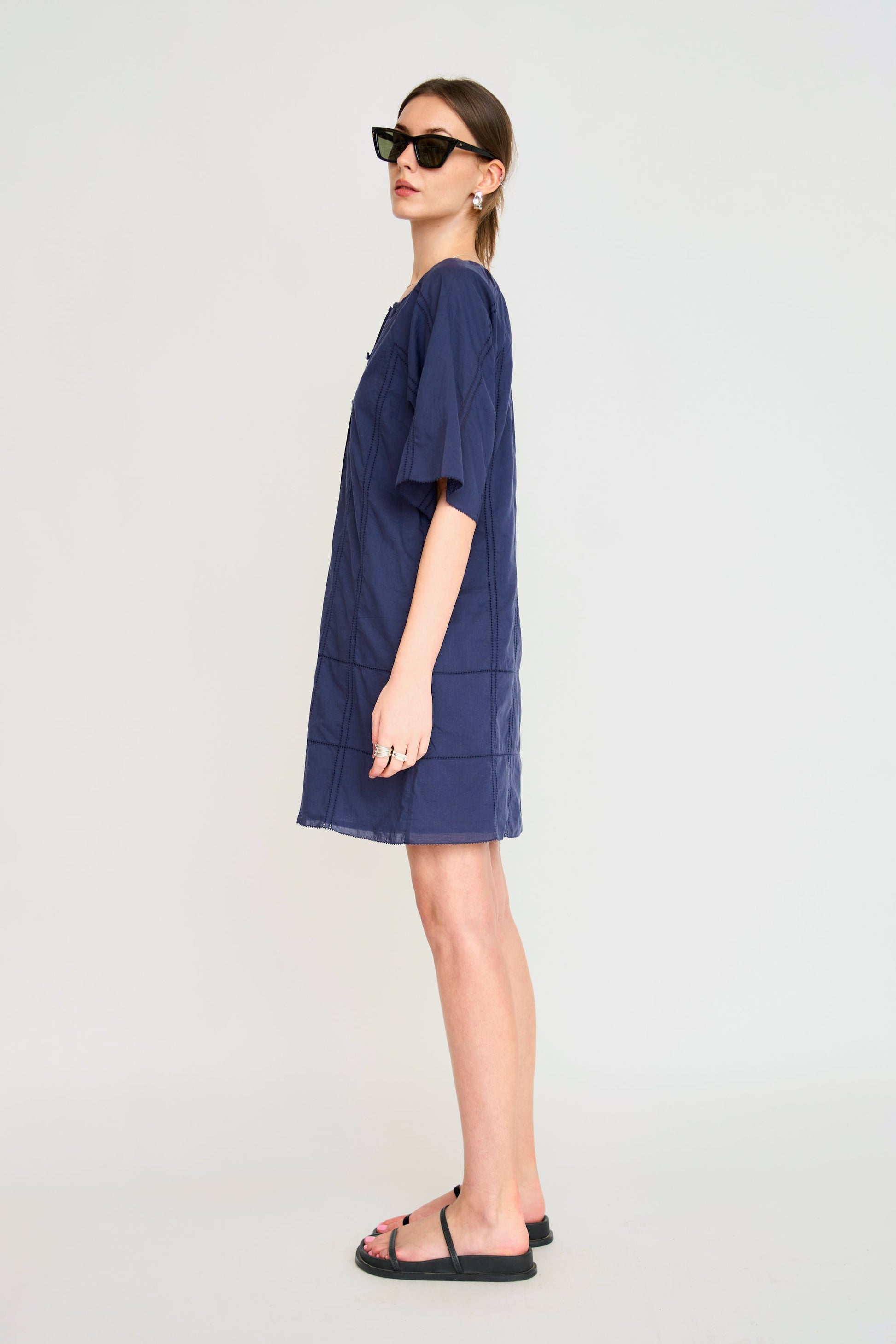 Blue cotton short dress on a hanger in store