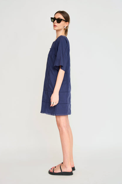 Blue cotton short dress on a hanger in store