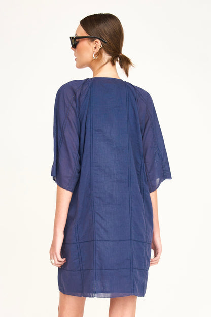Blue cotton short dress on a hanger in store