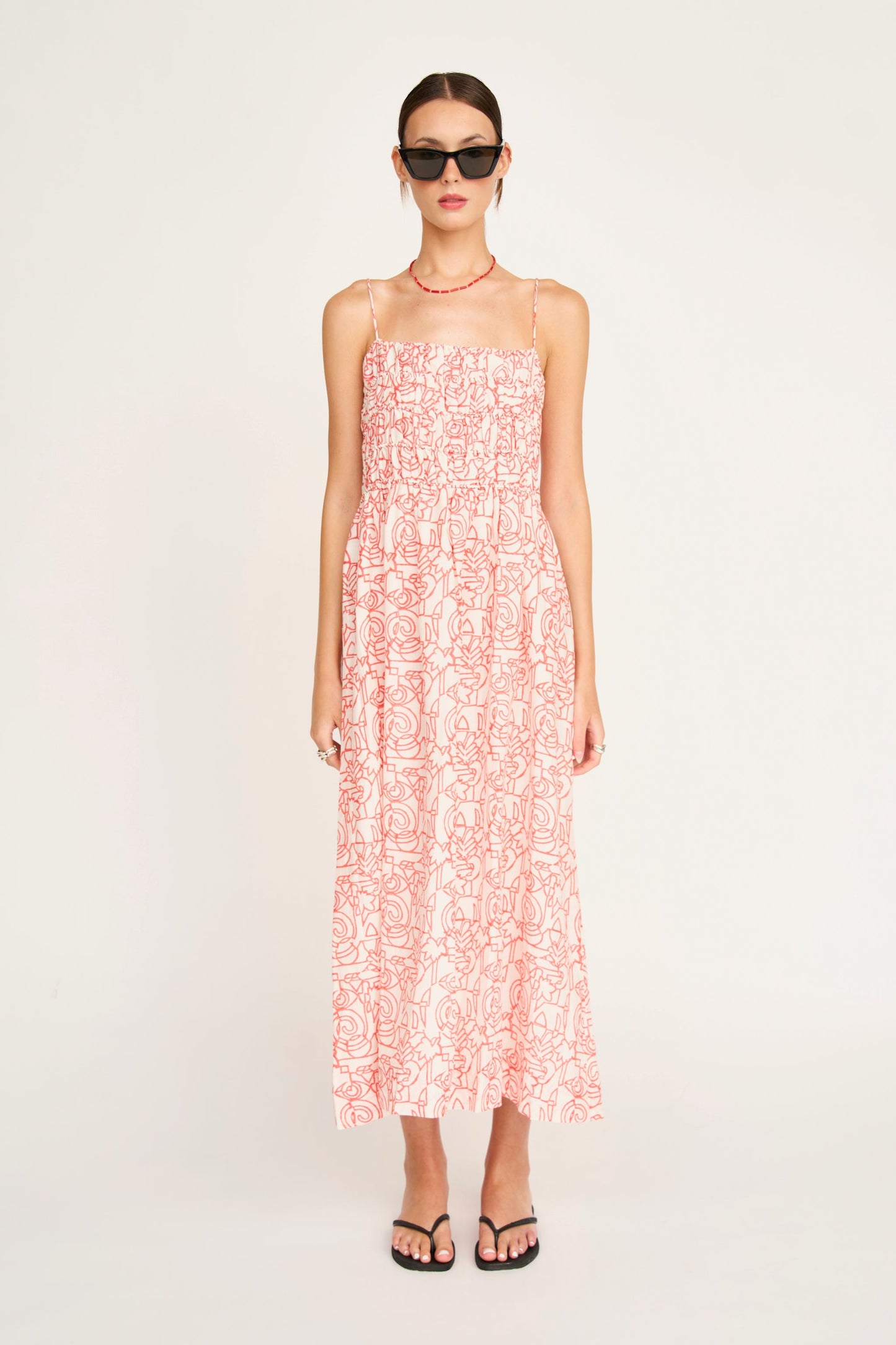 Red cotton midi dress on a hanger in store