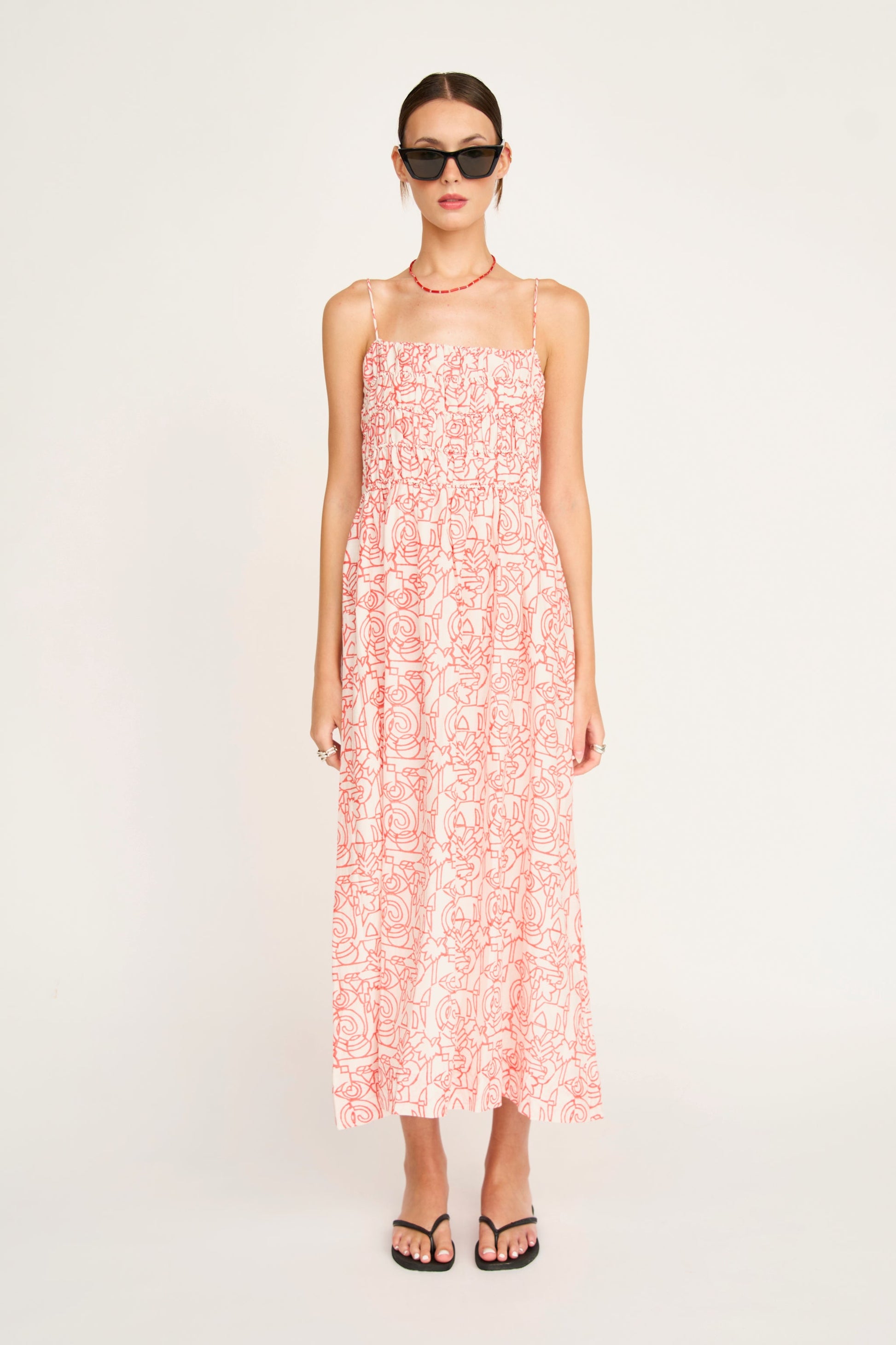 Red cotton midi dress on a hanger in store