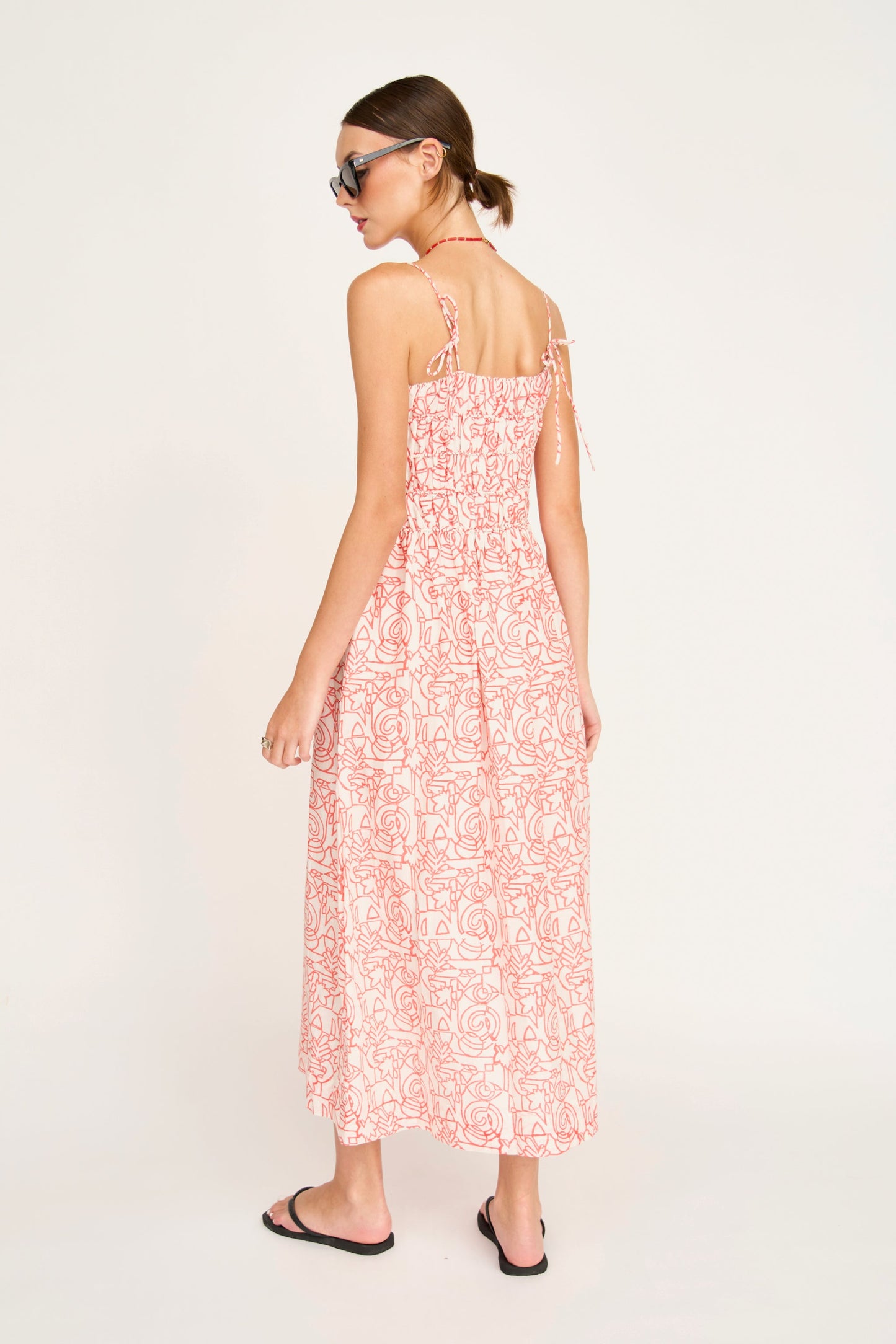 Red cotton midi dress on a hanger in store