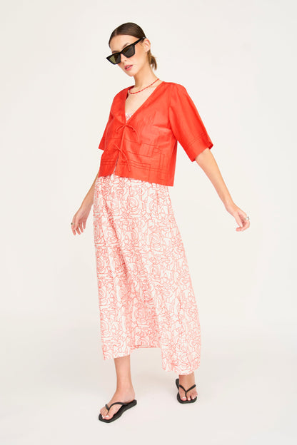 Red cotton midi dress on a hanger in store