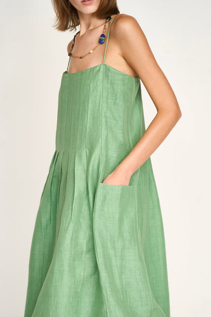 Green linen maxi dress on a hanger in store