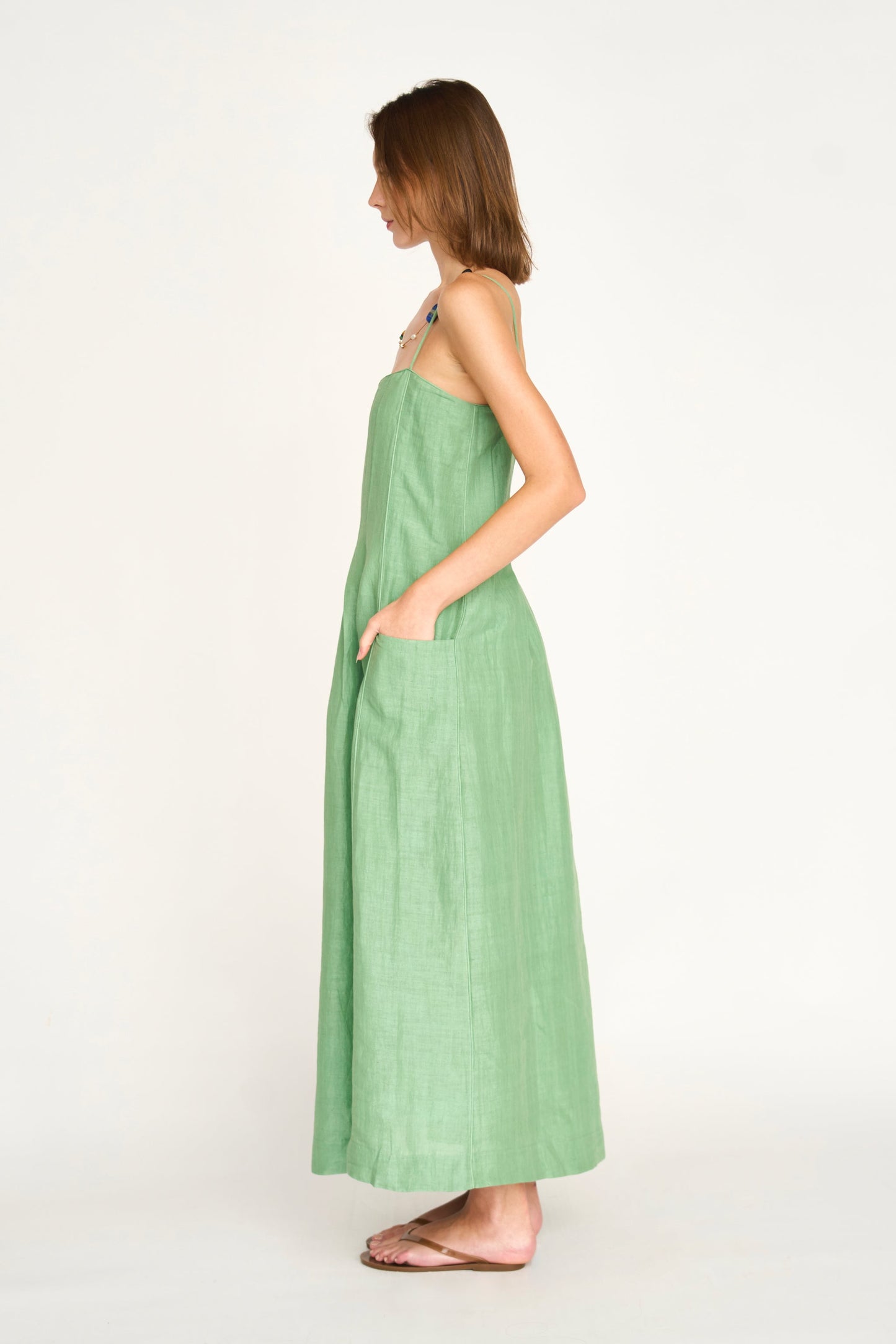 Green linen maxi dress on a hanger in store