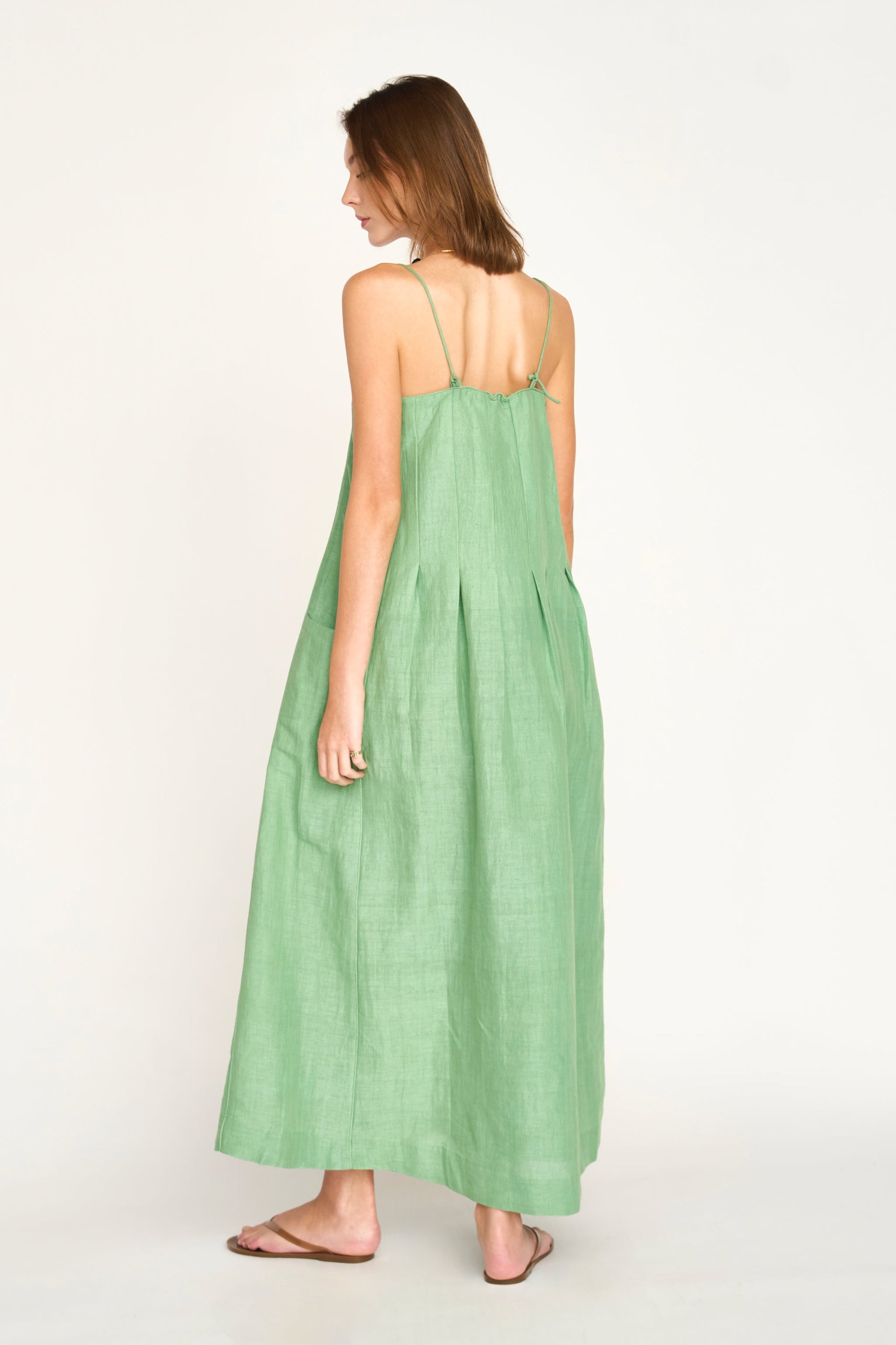 Green linen maxi dress on a hanger in store