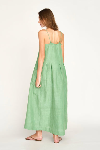 Green linen maxi dress on a hanger in store