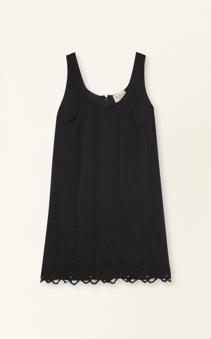 Black eyelet mini dress on a hanger in store